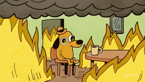 The 'this is fine' dog sitting calmly with coffee in a burning room