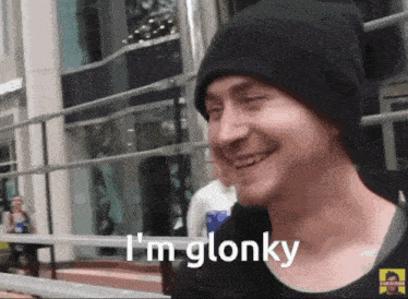 Man in a beanie grinning, captioned 'I'm glonky'