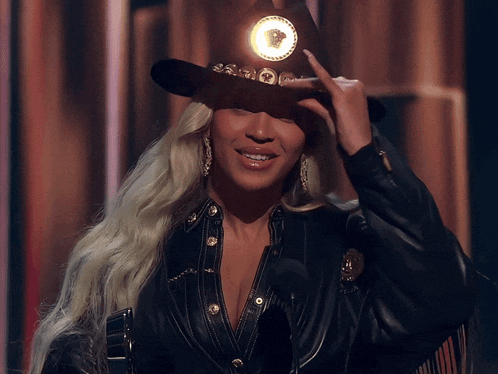 Beyoncé tipping a black cowboy hat, for the track that opened up debate about parity in country music